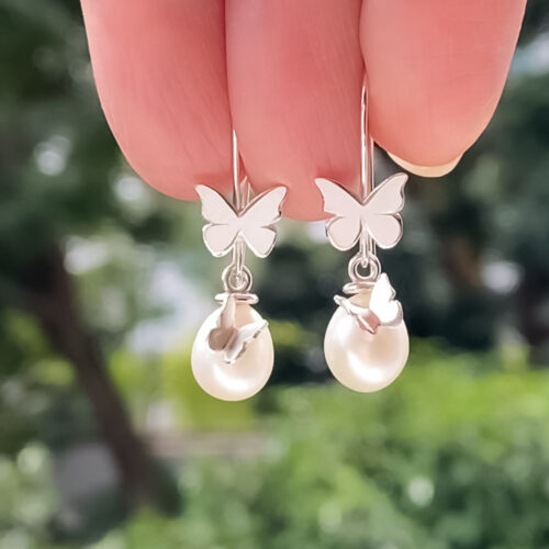 Fly with Me Pearl Earrings has two butterflies on each side. Handcrafted by Christina Lim